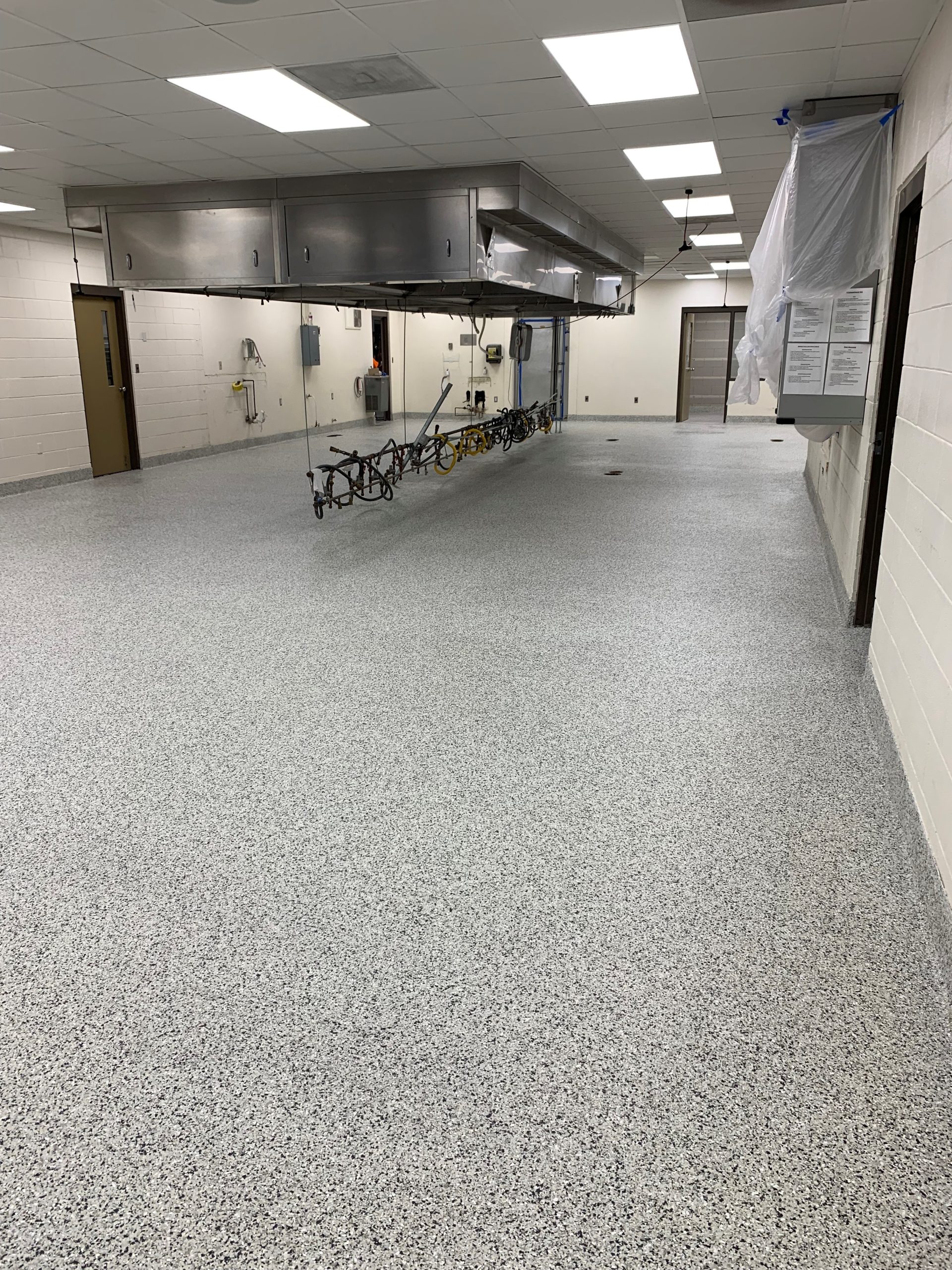 Industrial Epoxy Floor Coating in Manufacturing Facility – Decorative Resinous Coatings Manufacturing Facility Epoxy Floor Coating with Decorative Flake and Quartz Finishes
